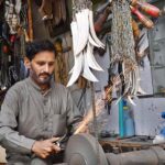 Blacksmith busy in sharpening knives to be used during the procession of Muharram at Chowk Khuda Bakhsh Road Nonaria