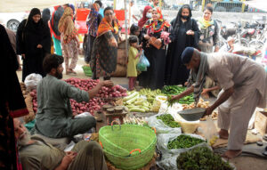 Women purchasing used clothes at Saturday Bachat Bazar