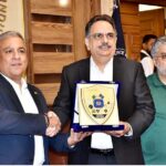 President Chamber of Commerce Abdul Ghafoor Malik presenting a shield to Pakistan Football Federation President Haroon Malik at SCCI