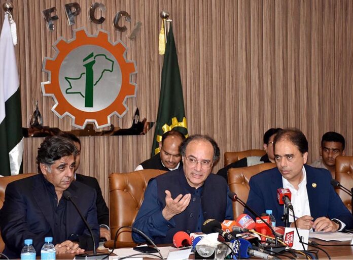 Federal Minister for Finance & Revenue, Muhammad Aurangzeb talking to media persons after meeting with Business community at FPCCI