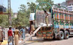 Labourers are busy loading corn sacks on a delivery truck