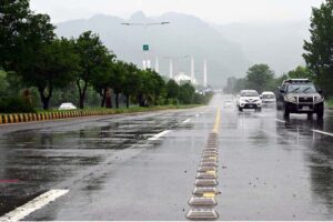 Vehicles on the way at Islamabad Highway during rain that experienced the Federal Capital.