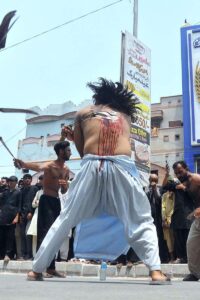 Mourners oozing themselves with knives and chains during procession on 9th Muharram ul Harram. Muharram Ul Haram is known as the first month of the Islamic calendar and the mourning month in remembrance of the martyrdom (Shahadat) of Hazrat Imam Hussain (RA), the grandson of the Holy Prophet Mohammad (PBUH).