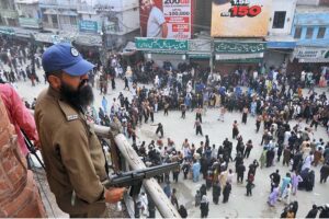 Security official standing high alert to avoid any untoward incident during procession on 10th of Holy Month of Muharramul Harram at Ghanta Ghar Chowk. Muharram is the mourning month in remembrance of the Shahadat of Hazrat Imam Hussain (RA), the Grandson of the Holy Prophet Mohammad (PBUH).