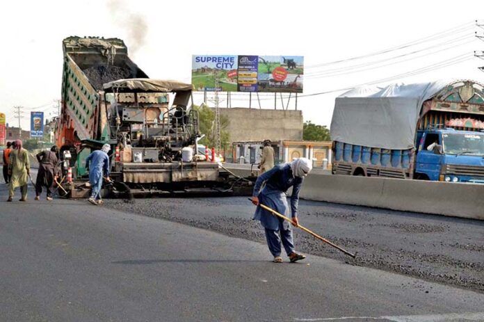 Workers are using heavy machinery to repair the GT Road near Shahdara and make the journey comfortable for commuters