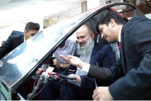 Federal Minister for Commerce Jam Kamal Khan rides a solar car designed by a student of the National University of Technology (NUTECH) at an inspiring Open House event and Job Fair.