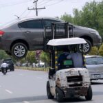 A traffic warden moving an illegally parked car with the help of lifter