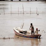 Fishermen setting net for catching fishes at Rice Canal