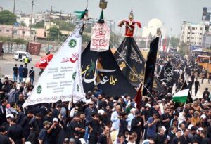 Mourners offering Zuhar prayers at M.A. Jinnah Road during the procession of 9th Muharram-ul-Haram. Muharramul Harram known as the first month of the Islamic calendar and the mourning month in remembrance of the martyrdom (Shahadat) of Hazrat Imam Hussain (RA), the grandson of the Holy Prophet Mohammad (PBUH).