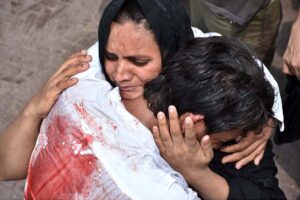 A mourner weeping along with his mother during procession on 10th of Muharram-ul-Haram. Muharram is the mourning month in remembrance of the Shahadat of Hazrat Imam Hussain (RA), the Grandson of the Holy Prophet Mohammad (PBUH).