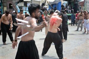Mourners oozing themselves with knives and chains during the procession of Ashura on 10th Muharram-ul-Harram at Tibet Center. Muharram is the mourning month in remembrance of the martyrdom (Shahadat) of Hazrat Imam Hussain (RA), the grandson of the Holy Prophet Mohammad (PBUH).