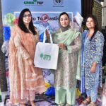 Chairperson of Women's Chamber of Commerce, Dr. Maryam Nauman, distributing bags among the public during a seminar ‘’No to Plastic campaign” on the initiative of Chief Minister Punjab organized by WCCIS