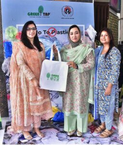 Chairperson of Women's Chamber of Commerce, Dr. Maryam Nauman, distributing bags among the public during a seminar ‘’No to Plastic campaign” on the initiative of Chief Minister Punjab organized by WCCIS