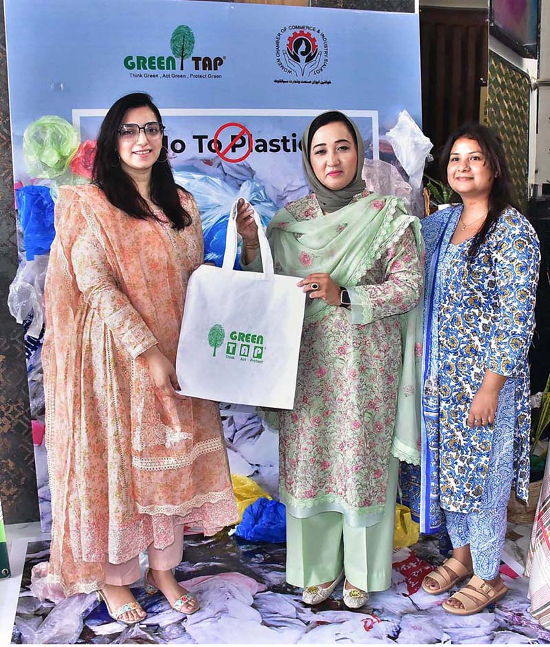 Chairperson of Women's Chamber of Commerce, Dr. Maryam Nauman, distributing bags among the public during a seminar ‘’No to Plastic campaign” on the initiative of Chief Minister Punjab organized by WCCIS