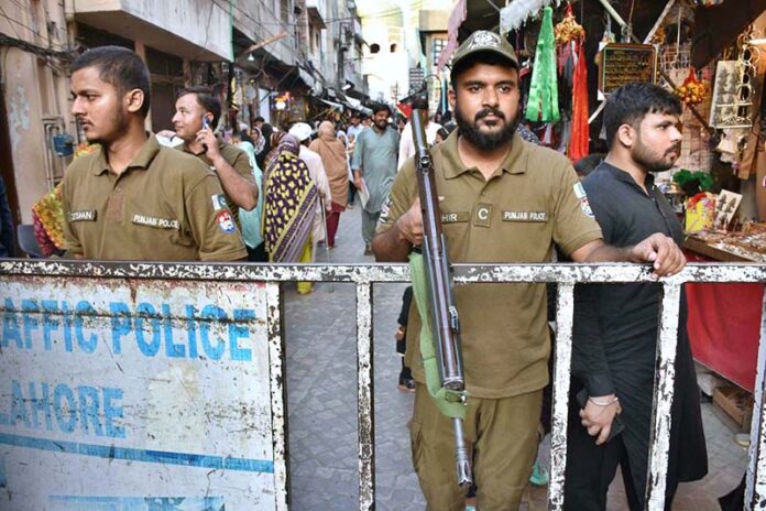 Policemen standing alert to avert any untoward incident at Bibi Pak Daman Bazaar