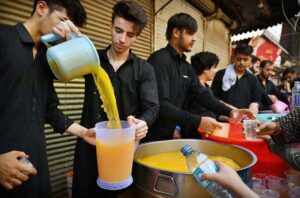 Volunteers setup sabeel and serving drinks to the mourners during Ashura procession at Kucha Risaldar on 10th of the Holy Month of Muharram ul Haram. Muharram is the mourning month in remembrance of the martyrdom (Shahadat) of Hazrat Imam Hussain (RA) the grandson of the Holy Prophet Mohammad (PBUH).
