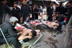 Volunteers giving first aid to mourners during Zuljinnah procession on 10th of Muharram ul Haram at Kucha Risaldar.
