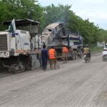 Labourers busy repairing Bari Imam Road during repairing and development work in Federal Capital
