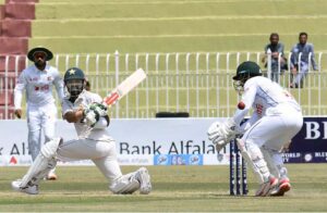 Pakistani batsman Mohammad Rizwan celebrates after scoring century (100 runs) during the 2nd day of the 1st Test cricket match between Pakistan and Bangladesh teams at the Rawalpindi Cricket Stadium