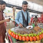 A vendor busy in frying ‘Tawa Kaleji’ for customers at his roadside setup
