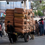 A labourer on the way pulling a heavily loaded handcart to deliver the stuff to shops at Liaquat Bagh