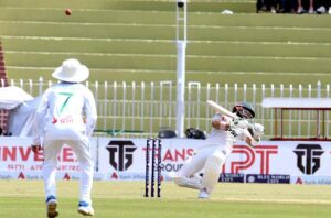 Pakistani batsman Mohammad Rizwan celebrates after scoring century (100 runs) during the 2nd day of the 1st Test cricket match between Pakistan and Bangladesh teams at the Rawalpindi Cricket Stadium