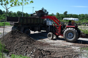 CDA workers clearing ground for planting trees on the greenbelt along Murree road