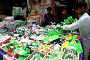 Vendors on Gumpat Road sell Pakistani flags and other items in preparation for Independence Day