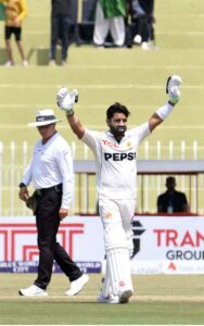 Pakistani batsman Mohammad Rizwan celebrates after scoring century (100 runs) during the 2nd day of the 1st Test cricket match between Pakistan and Bangladesh teams at the Rawalpindi Cricket Stadium