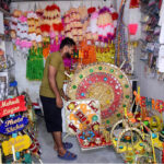 A vendor displays traditional mehndi thaal and other stuff used for wedding functions at Sadiqabad