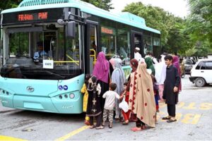 Eager passengers stand in line to board the newly launched electric bus in the Federal Capital.