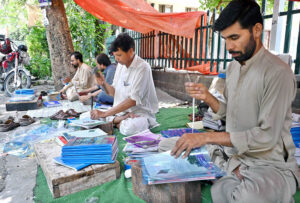 A garment vendor selling, a beautiful outfits for tiny Patriots with big style on upcoming celebrating Independence Day, 14th August, at Aabpara Market in Federal Capital.