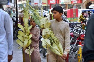 Youngsters displaying handicraft decoration item to attract the customer at Shafi Bazaar.