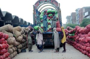 Laborers are unloading onions from the delivery truck at Vegetable Market-