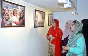 -Female visitors are keenly viewing photographs depicting Indian brutality against Kashmiris at the photo exhibition inaugurating on Yaum Istehsal Kashmir (Exploitation Day) at the Arts Council in the city.