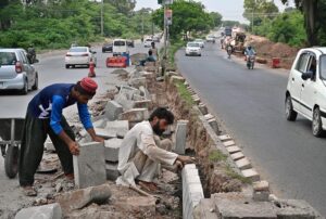 Heavy machinery is being used for the construction of bridge at the site of under construction 10th Avenue during development work in Federal Capital.