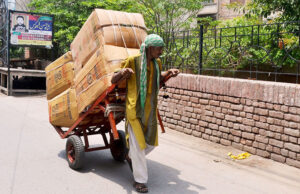 A laborer on the way pulling a heavily loaded handcart to deliver the stuff to shops at Bohar Gate.