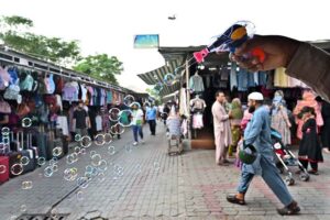A vendor making bubble with bubble gun to attract the customers at Weekly Bazaar Peshawar Mor in Federal Capital.