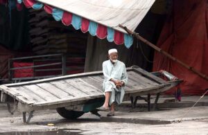 An elderly labourer taking rest on his cart at Gunj Mandi.