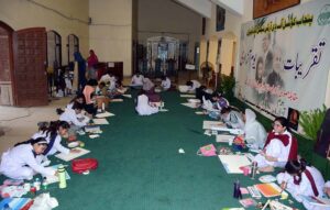 An art student participates in a painting competition that combines art and calligraphy, organized by the Punjab Arts Council Faisalabad for International Youth Day.