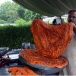 A vendor prepares traditional Katlamas, a famous local delicacy, enticing customers with the savory aroma and authentic taste at his roadside stall