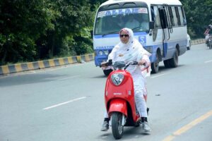 Woman on the way riding Scooty heading towards her destination