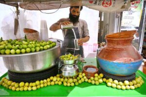 Vendor preparing fresh lemon juice for customers at Sadar Road during hot and humid weather in Provincial Capital.