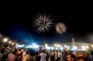 A large number of people attending firework celebration on the eve of Independence Day of Pakistan at F-9 Park