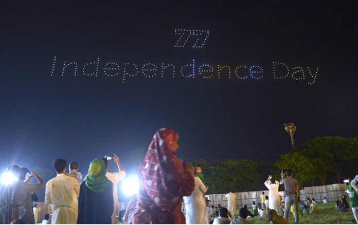 A large number of people witnessing the first Drone Light Show organized by Govt of Pakistan in the federal capital to commemorate the Independence Day at F-9 Park