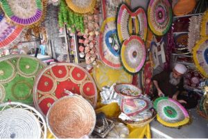 A shopkeeper crafts a wedding garland using fresh local currency at his setup in the Sadkabad area of the twin cities.