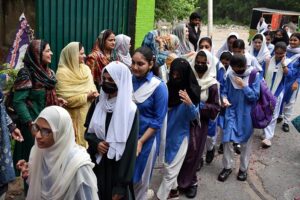 School teachers welcome the students on the opening day after Summer Vacation as Students arrive to attend their first day of school