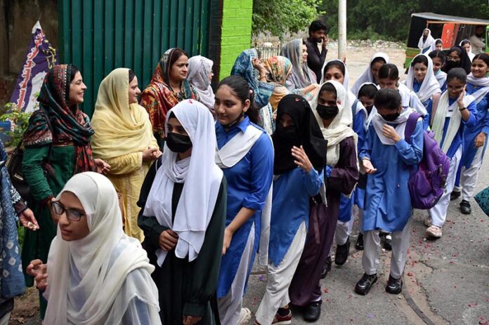 School teachers welcome the students on the opening day after Summer Vacation as Students arrive to attend their first day of school