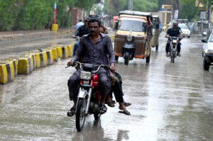A motorcyclist on the way during heavy rain in the city