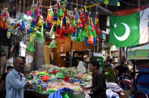 Shopkeepers displaying the different stuff related to Independence Day at Urdu Bazar as the nation starts preparations to celebrate Independence Day in befitting manners.